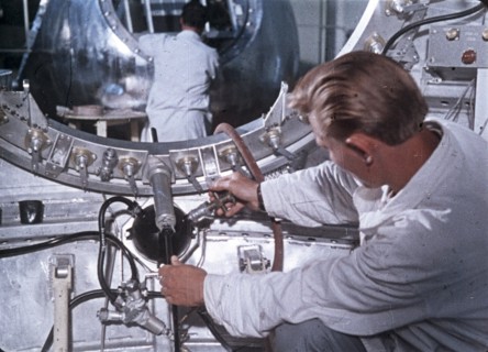 Work being done on the vostok 1 capsule in preparation for gagarin's historic flight, 1961, this is a still from a soviet film about the space program.