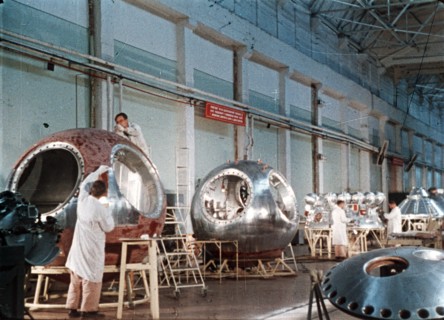 Work being done on the vostok 1 capsule in preparation for gagarin's historic flight, 1961, this is a still from a soviet film about the space program.