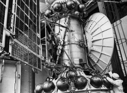 A technician with a working model of the venera 15 and 16 soviet space probe which is to be used for tests, 1982.