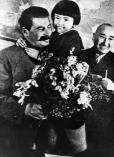 Joseph stalin receiving a bouquet of flowers from engelsina (gelya) markizova, the 7-year-old daughter of the second secretary of the buryat-mongolian regional party committee in 1936, stalin had him ...