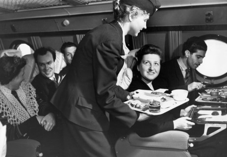 A stewardess serving a meal to passengers aboard a tu-114 airliner (at the time, the world's largest), 1959.