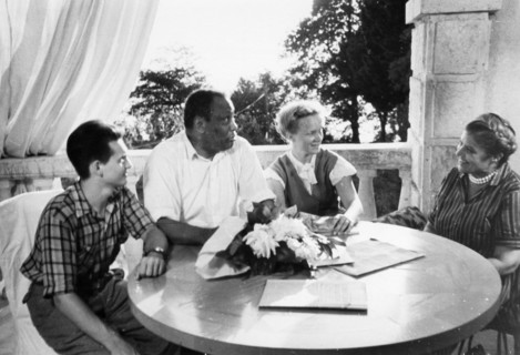 Paul robeson and his wife eslanda during a visit to a summer resort in sochi, august 1958,  they are sitting on the veranda of the 'new sochi' sanitorium with their guests adoi korotkevich, a tashkent...