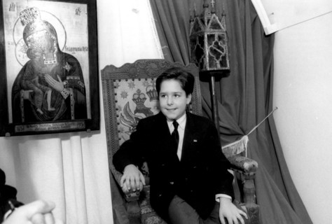 Kostroma, russia 9/92: 11-year-old grand duke georgy mikhailovich romanov sits in the czar's chair in the ipatyevsky monastery, where the first romanov, mikhail, sheltered his mother in 1613 during th...