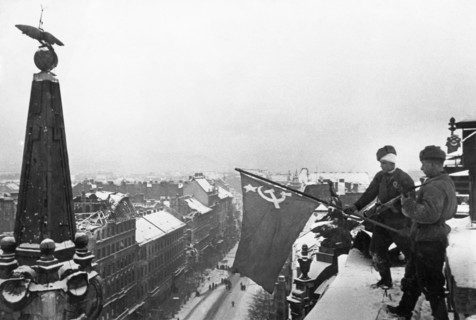 World war 2, soviet soldiers raising the flag of victory above a city building in budapest, hungary after the capture of the hungarian capital, february 1945.