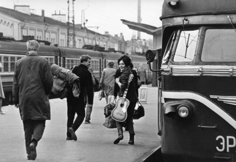 A young russian couple at a moscow train station, leaving the city with rucksack and guitar, vacation, ussr, 1970.