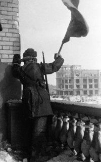 World war 2, battle of stalingrad, february 1943: a red army soldier raises the soviet flag (hammer and sickle) on the roof of a downtown stalingrad depatment store where the staff of field marshal vo...