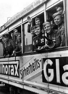 Soviet soldiers riding a berlin tram, 1945, after germany's surrender.