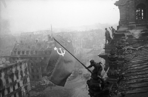 Red army soldiers raising the soviet flag over the reichstag in berlin, germany, april 30, 1945.