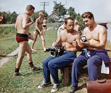 Soviet cosmonauts (l to r) vladislav volkov, viktor gorbatko, and anatoly filipchenko looking over a camera during a break from training for the soyuz 7 mission, ussr 1969.