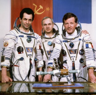 Salyut 7, soyuz t-6, cosmonauts aleksandr ivanchenkov, vladimir dzhanibekov, and jean-loup chrétien (france) pose with a model of the salyut 7 and soyuz spacecraft, 1982.