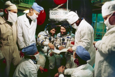 Mir, soyuz tm-2, cosmonauts aleksandr laveykin and yuri romanenko try on their space suits prior to launch at baikonur, 1987.