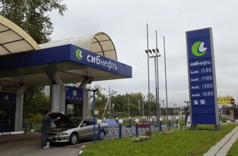Moscow, russia, august 16, 2004, a gas station and an advertisement stand bearing sibneft oil company logo, russian slavneft oil company is selling about a hundred gas stations in moscow, from now on ...