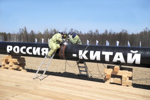 Amur region, russia, april 27, 2009, workers welding the first segment of a branch pipeline which will run into china from the eastern siberia – pacific ocean (espo) oil pipeline, the slogan on the pi...