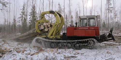 A tractor logging trees in the eastern siberia which is traditionally famous for the taiga woods , irkutsk region , russia, february 19 2000, a considerable part of the russian lumber is exported from...