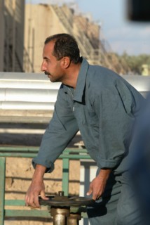 Baghdad, iraq, february 8 2003, worker (in pic) at one of large oil refineries on the outskirts of baghdad.