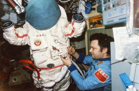 Soyuz tm-2, soviet cosmonaut yuri romanenko aboard the mir space station getting ready for a spacewalk (eva), 1987.