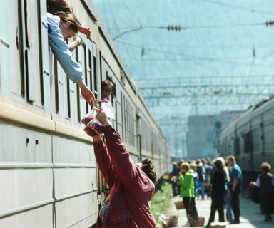 Irkutsk region, russia, october 8, 2003, a woman, resident of the town of slyudyanka, selling berries to passengers on the railway station, such trade is the main way of earning money for people in sl...