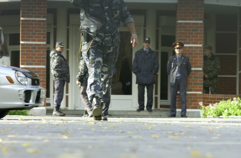 Police and militia at the entrance of the 'yukos' office in zhukovka where searches were resumed in connection with tax evasion and embezzlement charges, october 9, 2003.
