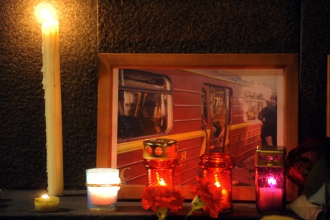 Moscow, russia, march 30, 2010, a photograph of a damaged metro carriage and candles to commemorate victims of the metro bomb explosions, blasts rocked two stations on sokolnicheskaya line of the mosc...
