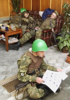 Beslan (north ossetia), russia, september 2, 2004, servicemen after a 24-hour duty around the building of the school no 1 in the city beslan seized by terrorists, have a rest.