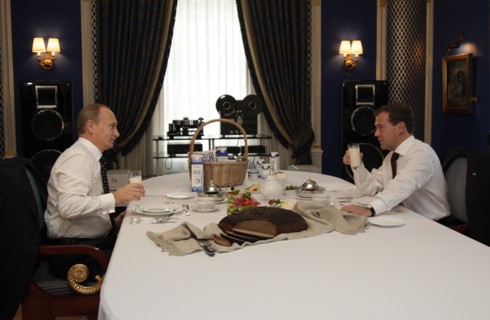Moscow region, russia, october 1, 2010, president of russia dmitry medvedev (r) and prime minister vladimir putin have a snack together during their meeting at gorki residence  with milk products from...
