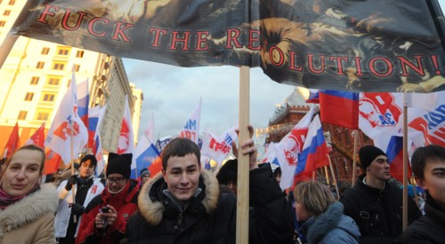 Moscow, russia, december 12, 2011, young demonstrators carry a placard reading fuck the revolution! during a rally staged by pro-kremlin youth groups in central moscow, the event took place two days a...