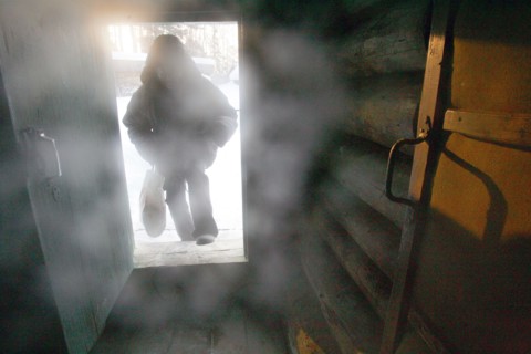 A man entering the predbannik (dressing room) of the banya (russian steam bath) in elnat (yelnat) village in the ivanovo region of russia, 2006.