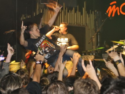 Youth raise their hands as they listen to music at 'tochka' club, the venue of the 'punks in city x' festival, august 26, 2006.