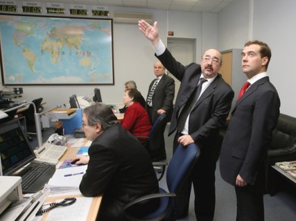Russia's first deputy prime minister dmitry medvedev, far right, listens to acting kosmicheskaya svyaz general director yuri izmailov, 2nd right, at the main office of kosmicheskaya svyaz satellite op...