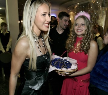 Tv host and socialite ksenia sobchak, left, smiles as she is offered chocolates in the shopping centre 'european' at the russian premiere of william heins comedy pledge this! starring paris hilton, ks...