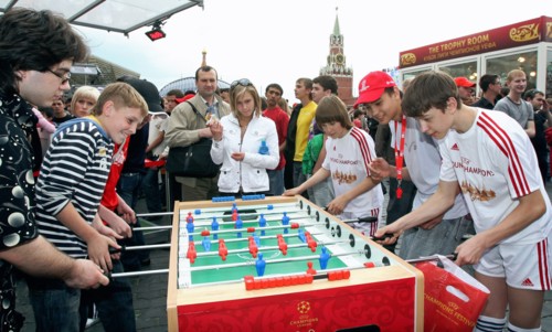 Teenagers playing a game of foosball in red square, moscow, the venue of the 2008 uefa champions festival, moscow, russia, may 2008.