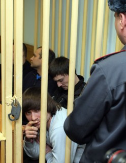 Suspects of murder of journalist anna politkovskaya, dzhabrail makhmudov (foreground), sergei khadzhikurbanov and ibragim makhmudov (l-r, background) appear at the hearing of moscow district military ...