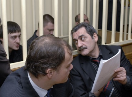 Dzhabrail makhmudov, pavel ryaguzov and sergei khadzhikurbanov (l-r, background), accused of murdering anna politkovskaya, novaya gazeta columnist, appear at the hearing of moscow district military co...