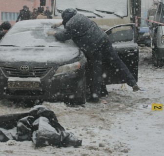 Moscow, russia, december 29, 2008, the body of tax crimes police officer roman maslov lies near his toyota car in which he was shot dead in the yard of his house.