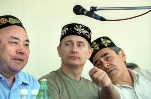 Kazan, tatarstan, russia, june 24 2000, russian president vladimir putin wearing a tatar embroidered skull-cap on his head seen attending an open-air holiday events organized outside kazan, sabantui h...