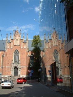 Riga, latvia, 2003, the lutheran gertruda's church in baznicas street beside a modern multi-storey car park, park.