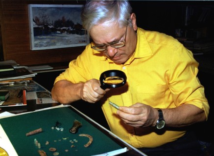 Alexander avdonin, organiser of excavations of the last russian tsar's remains, examine beads, catridge-cases, pistol bullets, hooks, buttons, a fragment of a golden bracelet that he relates to remain...