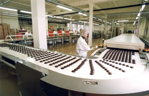 Laima chocolate shop: automatic production line for chocolate coated marshmallow at the 'laima' confectionary factory in riga, latvia, 2003.