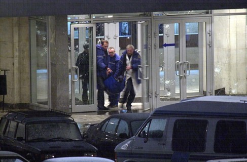 Moscow, russia, october 26 2002: chechen hostage crisis, a dead body is carried out of the theater center, presumably it is the body of the man who entered the building tonight, probably a relative of...