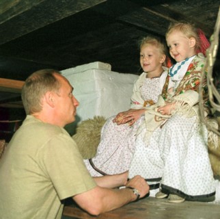 Petrozavodsk, karelia, russia, august 19 2001, president vladimir putin who spends part of his vacation in karelia pictured talking with natasha and vasilisa popovs ,participants of the 'kizhi' folklo...