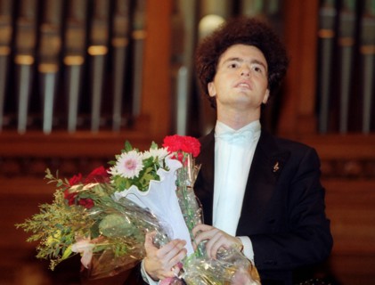 Moscow, russia, february 10 2002: world famous pianist yevgevy kisin (in pic) with flowers from his admirers at the festival marking the 10th anniversary of the triumph prize, yevgevy kisin played som...