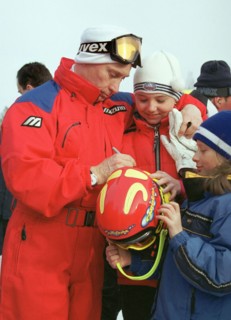 Irkutsk region, russia, march 27 2002, president vladimir putin giving autographs to little skiers while spending his brief vacation at the baikalskaya ski base in irkutsk region.