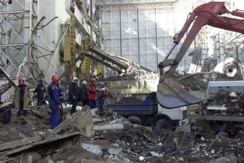 Baikonur, kazakhstan, may 14 2002: devastating fire at energia works: workers clearing debris of the destroyed roof of the assembly and test block where rocket-carrier 'energia' and russian space-shut...