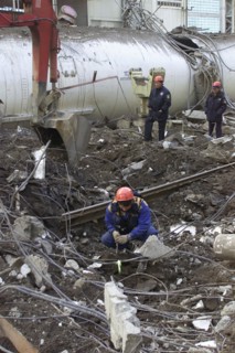 Baikonur, kazakhstan, may 14 2002: workers clearing the fragments of 'energia' rocket carrier and first russian space shuttle 'buran' from debris of the destroyed roof of the assembly and test block w...