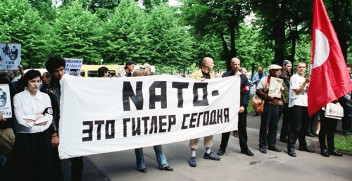 Riga, latvia, june 17, 2002: the protestors hold a banner reading 'nato is the hitler of our time', an authorized picket of latvian national bolsheviks protesting against latvia's joining nato, was he...