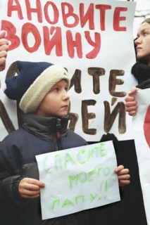 Moscow, russia, october 25 2002: a little boy whose father is being held hostage by terrorists at the palace of culture of the ball-bearing plant pictured participating in mass meeting of relatives of...