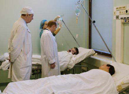 Moscow, russia,10/26/02: chechen hostage crisis: president vladimir putin (c) talks to doctors, president visited released hostages in need of medical attention who were taken to the sklifosovsky firs...