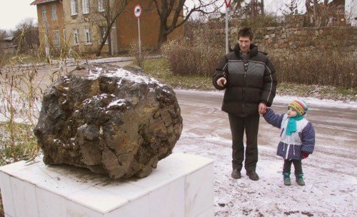 Kaliningrad, russia, december 5 2002: a meteorite (in pic) found in a sand pit near mamonovo was placed on a marble pedectal in a street of kaliningrad, (photo igor zarembo).