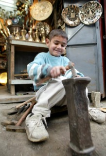 Baghdad, iraq, february 10 2003, a young craftsman pictured at work in a street of old baghdad.
