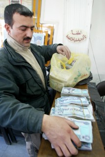 Baghdad, iraq, february 14 2003: an exchange office in baghdad, money is brought here in sacks because of the low price of the national currency - dinar, (photo itar-tass / vitaly belousov)  .